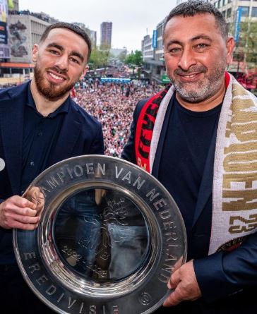 Orkun Kokcu and his father Halis Kokcu with a trophy